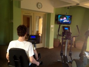 Watching TV while on the bike.